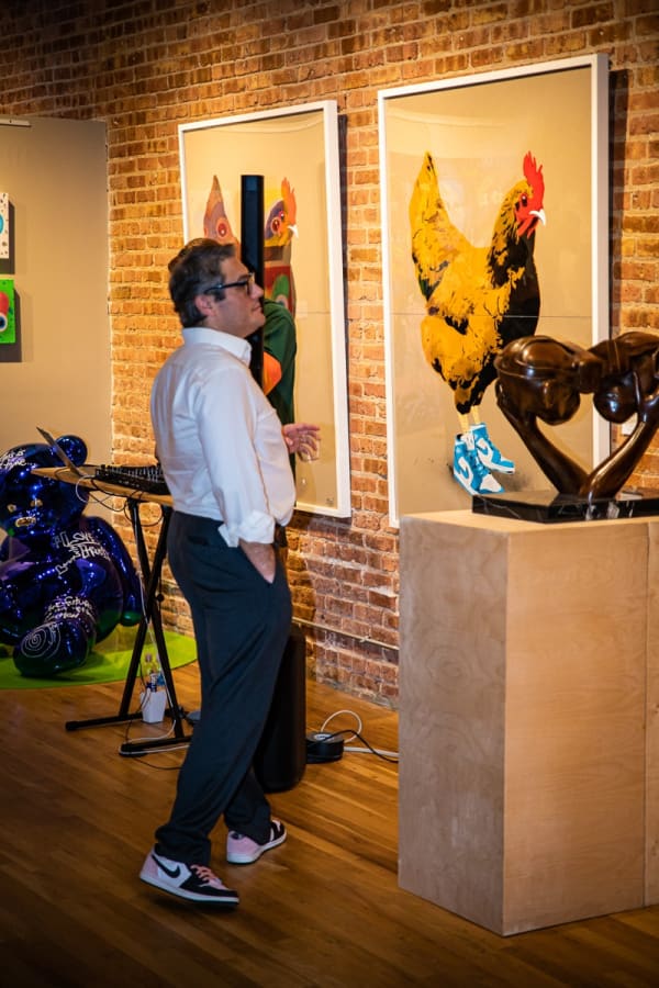 Man staring at sculpture in Carousel Fine Art's Chicago gallery space.