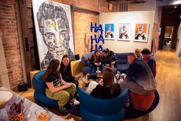 Crowd of people on couch in Carousel Fine Art's Chicago gallery space.