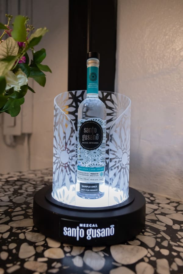 Tequila bottle displayed in Carousel Fine Art's Miami location for the Cayla Birk exhibition, "It's in the Cards."