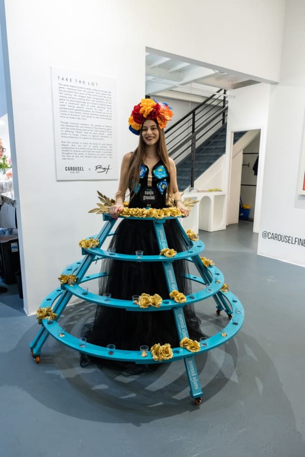 Woman in costume in Carousel Fine Art's Miami location for the Cayla Birk exhibition, "It's in the Cards."