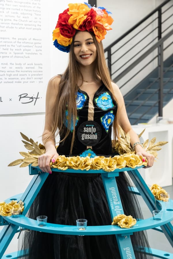 Woman in costume in Carousel Fine Art's Miami location for the Cayla Birk exhibition, "It's in the Cards."