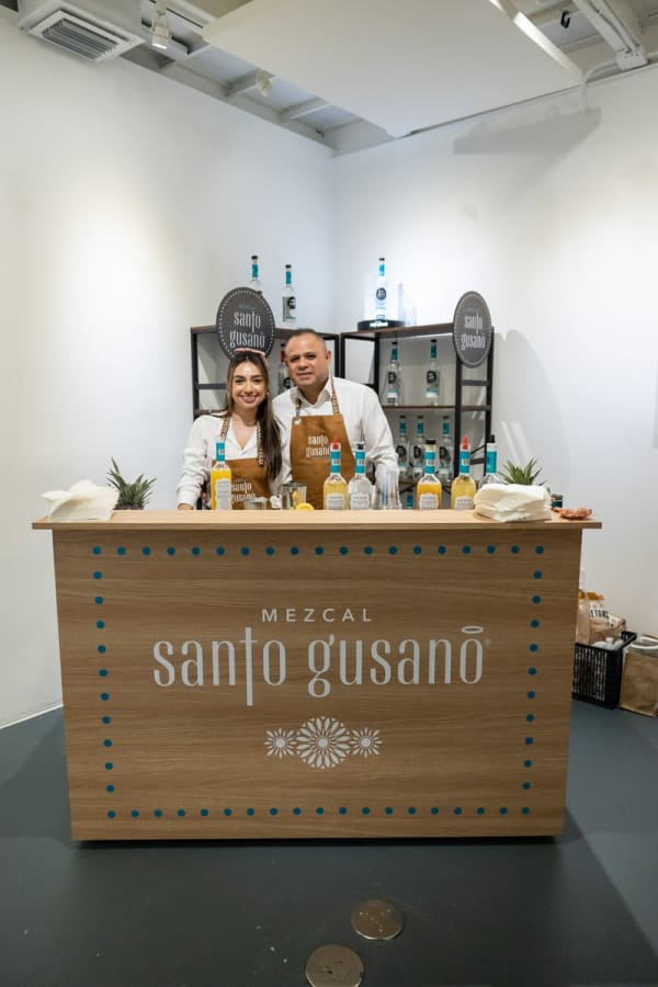 Bartenders at make-shift bar in Carousel Fine Art's Miami location for the Cayla Birk exhibition, "It's in the Cards."