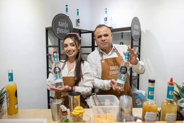 Bartenders posing in Carousel Fine Art's Miami location for the Cayla Birk exhibition, "It's in the Cards."