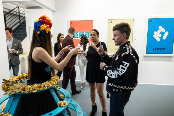 People in Carousel Fine Art's Miami location for the Cayla Birk exhibition, "It's in the Cards."