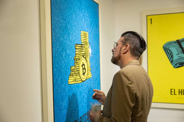 Man staring at painting by Cayla Birk in Carousel Fine Art's Miami location for the Cayla Birk exhibition, "It's in the Cards."