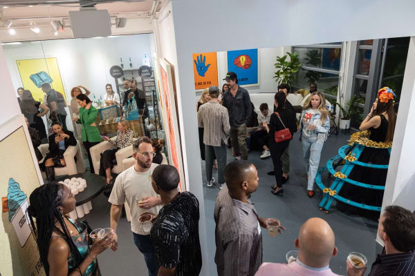 People in Carousel Fine Art's Miami location for the Cayla Birk exhibition, "It's in the Cards."