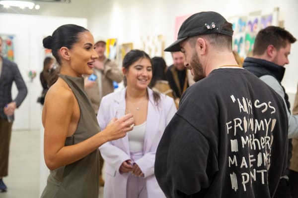 People in Carousel Fine Art's Atlanta gallery space during the spotlight exhibition for John Westbay titled "Love, Outside the Lines."