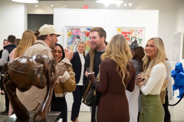 People in Carousel Fine Art's Atlanta gallery space during the spotlight exhibition for John Westbay titled "Love, Outside the Lines."