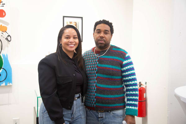 People posing in Carousel Fine Art's Atlanta gallery space during the spotlight exhibition for John Westbay titled "Love, Outside the Lines."