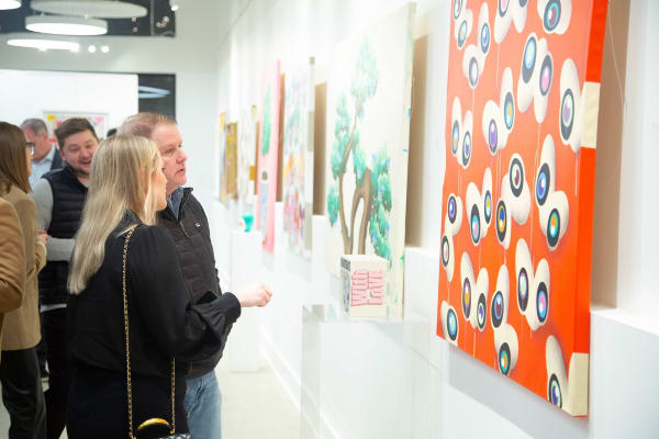 People staring at painting by John Westbay in Carousel Fine Art's Atlanta gallery space during the spotlight exhibition for John Westbay titled "Love, Outside the Lines."