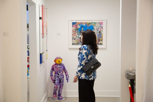 Woman staring at painting by Eric Alfaro displayed in Carousel Fine Art's Buckhead Village location during the exhibition "Spring Reverie."