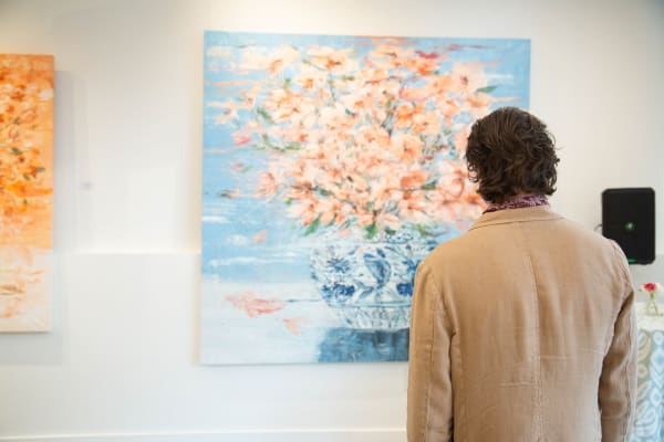 Man staring at painting by Eric Alfaro displayed in Carousel Fine Art's Buckhead Village location during the exhibition "Spring Reverie."