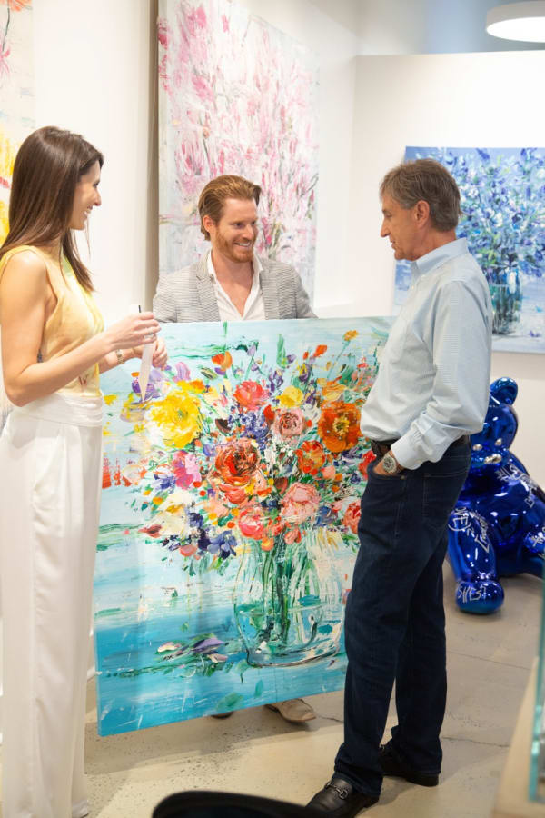 People in Carousel Fine Art's Buckhead Village location during the Eric Alfaro exhibition "Spring Reverie."