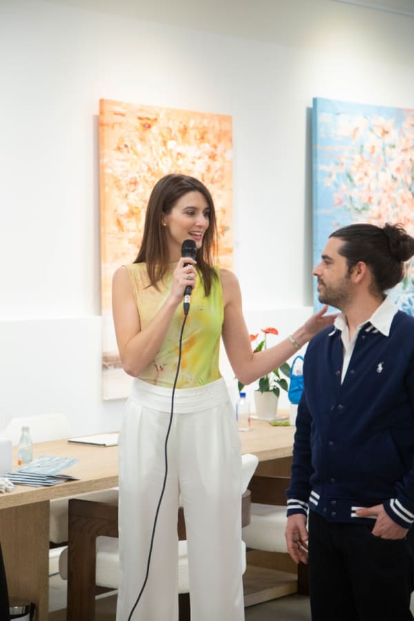 Gallery owner of Carousel Fine Art speaking during the Eric Alfaro exhibition "Spring Reverie."
