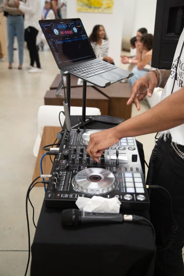 DJ playing music in Carousel Fine Art's Buckhead Village location during the Eric Alfaro exhibition "Spring Reverie."