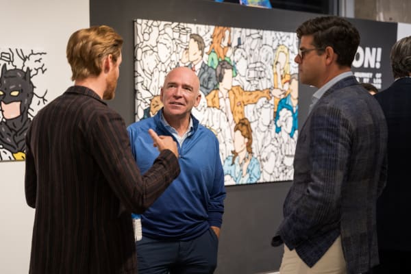People at a Chicago art event, a solo exhibition for artist Chance Cooper titled "Action!", hosted by Chicago art gallery Carousel Fine Art.