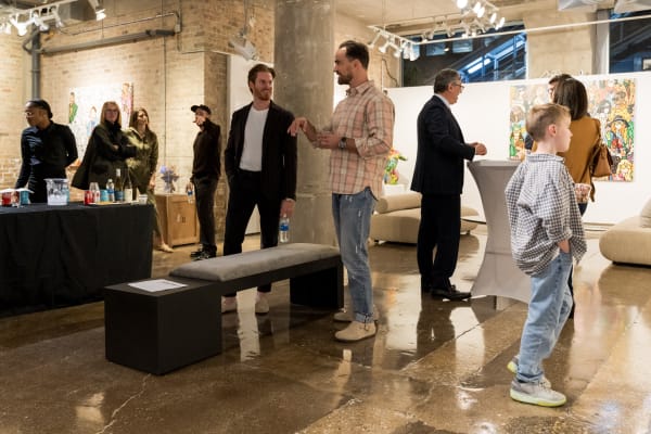 People at a Chicago art event, a solo exhibition for artist Chance Cooper titled "Action!", hosted by Chicago art gallery Carousel Fine Art.
