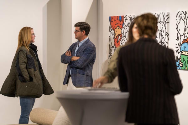 People at a Chicago art event, a solo exhibition for artist Chance Cooper titled "Action!", hosted by Chicago art gallery Carousel Fine Art.