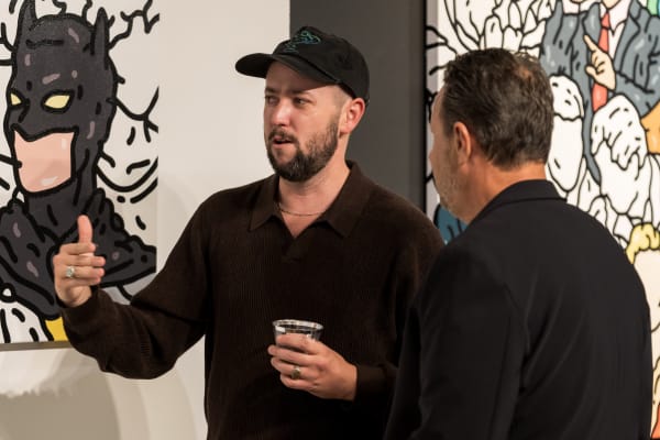 People at a Chicago art event, a solo exhibition for artist Chance Cooper titled "Action!", hosted by Chicago art gallery Carousel Fine Art.
