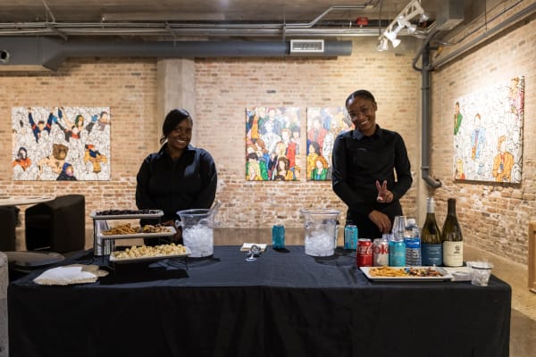 People at a Chicago art event, a solo exhibition for artist Chance Cooper titled "Action!", hosted by Chicago art gallery Carousel Fine Art.