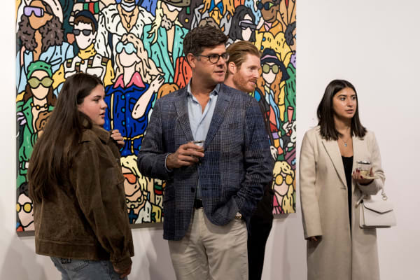 People at a Chicago art event, a solo exhibition for artist Chance Cooper titled "Action!", hosted by Chicago art gallery Carousel Fine Art.