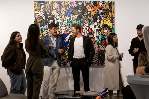 People at a Chicago art event, a solo exhibition for artist Chance Cooper titled "Action!", hosted by Chicago art gallery Carousel Fine Art.