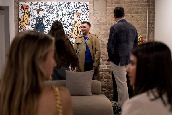 People at a Chicago art event, a solo exhibition for artist Chance Cooper titled "Action!", hosted by Chicago art gallery Carousel Fine Art.