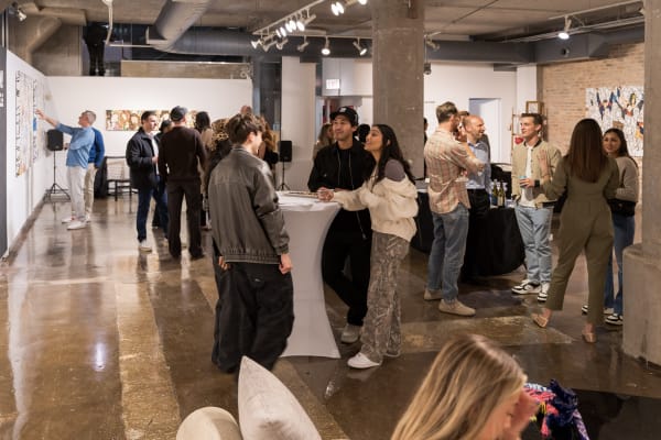 People at a Chicago art event, a solo exhibition for artist Chance Cooper titled "Action!", hosted by Chicago art gallery Carousel Fine Art.
