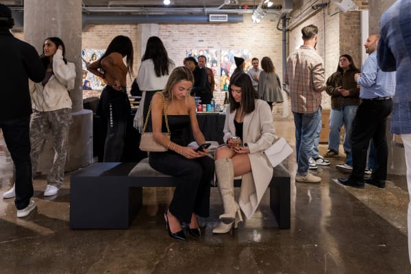 People at a Chicago art event, a solo exhibition for artist Chance Cooper titled "Action!", hosted by Chicago art gallery Carousel Fine Art.