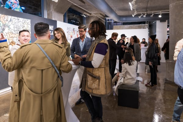 People at a Chicago art event, a solo exhibition for artist Chance Cooper titled "Action!", hosted by Chicago art gallery Carousel Fine Art.