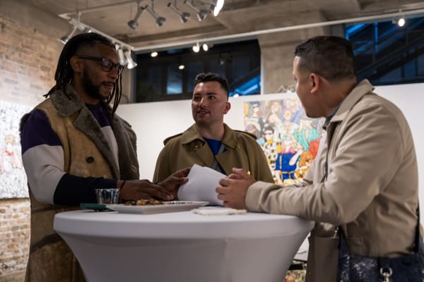 People at a Chicago art event, a solo exhibition for artist Chance Cooper titled "Action!", hosted by Chicago art gallery Carousel Fine Art.