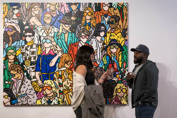 People at a Chicago art event, a solo exhibition for artist Chance Cooper titled "Action!", hosted by Chicago art gallery Carousel Fine Art.
