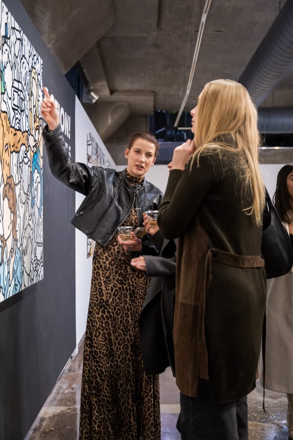People at a Chicago art event, a solo exhibition for artist Chance Cooper titled "Action!", hosted by Chicago art gallery Carousel Fine Art.
