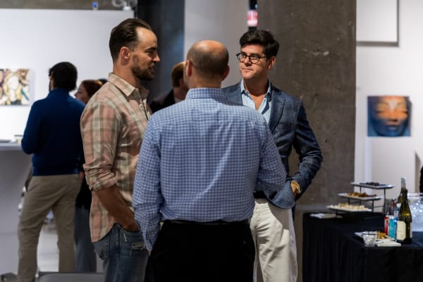 People at a Chicago art event, a solo exhibition for artist Chance Cooper titled "Action!", hosted by Chicago art gallery Carousel Fine Art.