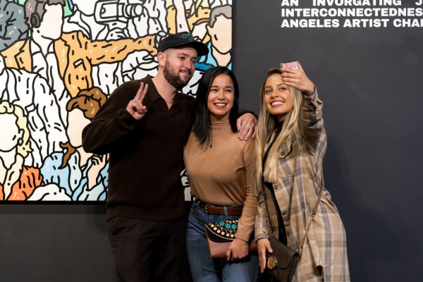 People at a Chicago art event, a solo exhibition for artist Chance Cooper titled "Action!", hosted by Chicago art gallery Carousel Fine Art.