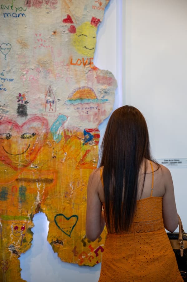 Woman staring at painting displayed at Carousel Fine Art's Miami gallery space for the exhibition, "If These Walls Could Talk."