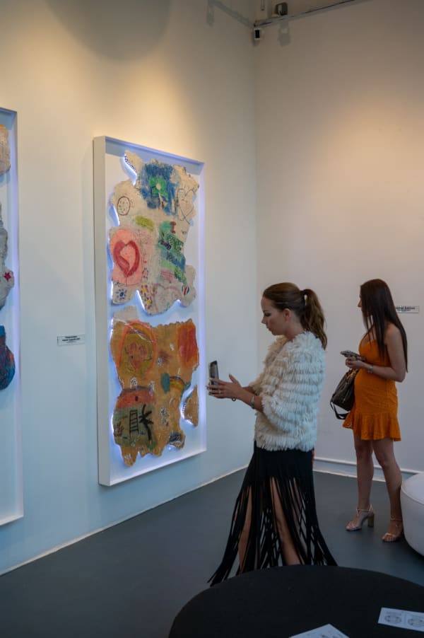 People at Carousel Fine Art's Miami gallery space for the exhibition, "If These Walls Could Talk."