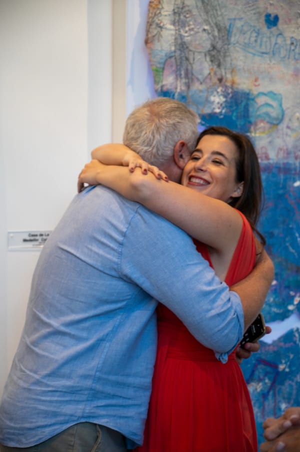 People hugging at Carousel Fine Art's Miami gallery space for the exhibition, "If These Walls Could Talk."