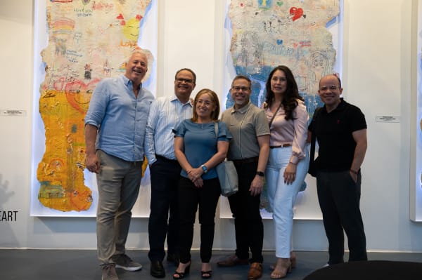 People posing for photo at Carousel Fine Art's Miami gallery space for the exhibition, "If These Walls Could Talk."