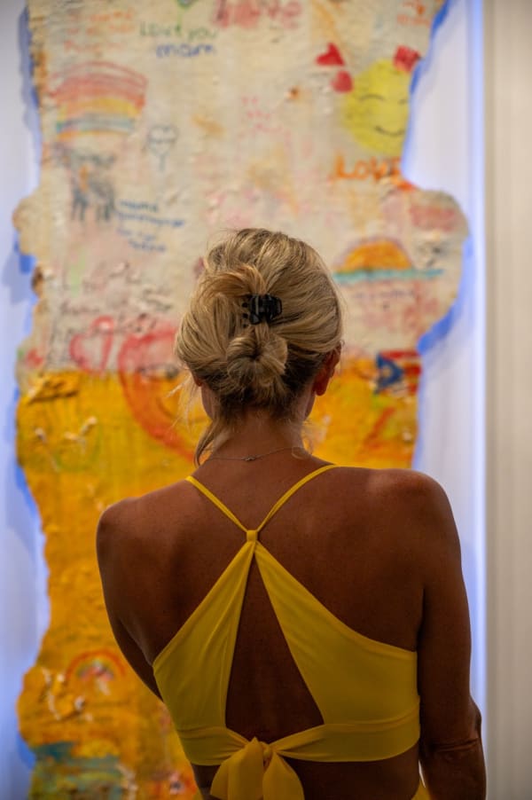 Woman staring at painting by Justin Garcia in Carousel Fine Art's Miami gallery space for the exhibition, "If These Walls Could Talk."