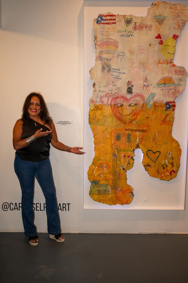 Woman in front of painting by Justin Garcia at Carousel Fine Art's Miami gallery space for the exhibition, "If These Walls Could Talk."