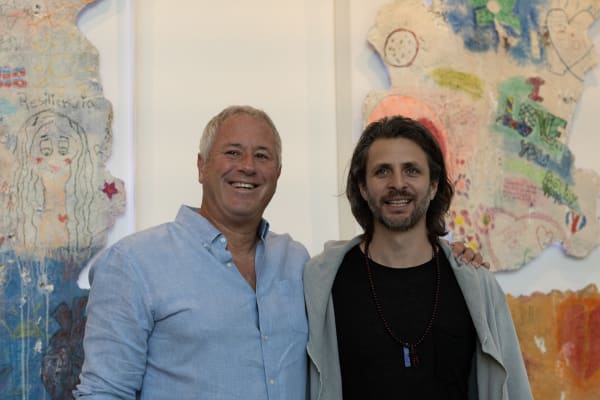 Men posing for photograph at Carousel Fine Art's Miami gallery space for the exhibition, "If These Walls Could Talk."