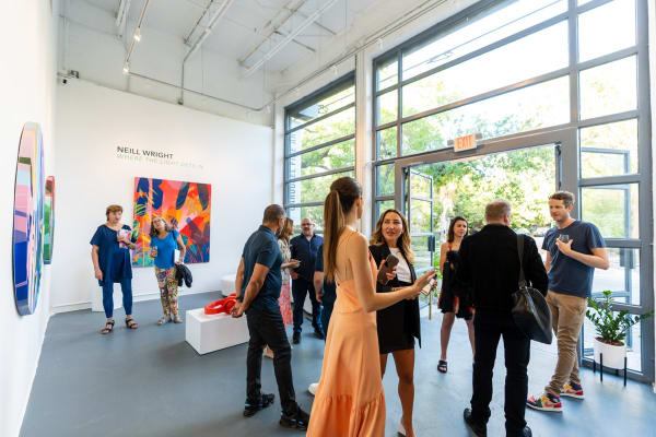 People inside Carousel Fine Art's Miami gallery space during Neill Wright's exhibition "Where the Light Gets In."