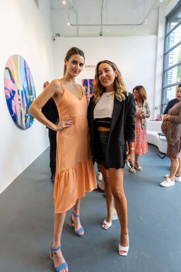 People inside Carousel Fine Art's Miami gallery space during Neill Wright's exhibition "Where the Light Gets In."