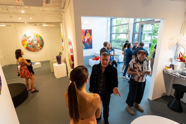 People inside Carousel Fine Art's Miami gallery space during Neill Wright's exhibition "Where the Light Gets In."