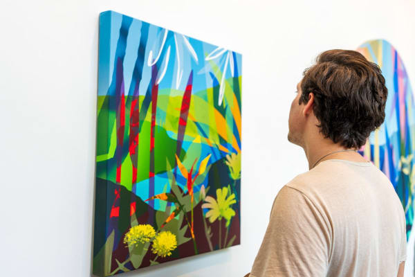 Man looking at painting by Neill Wright inside Carousel Fine Art's Miami gallery space during Neill Wright's exhibition "Where the Light Gets In."