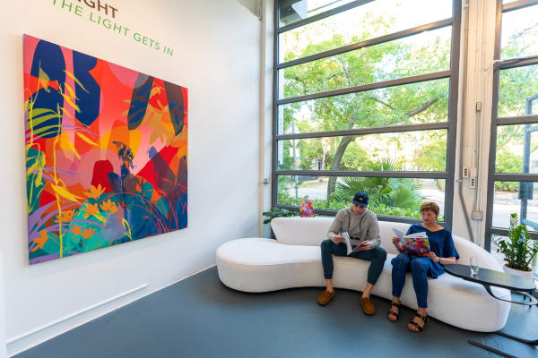 People inside Carousel Fine Art's Miami gallery space during Neill Wright's exhibition "Where the Light Gets In."