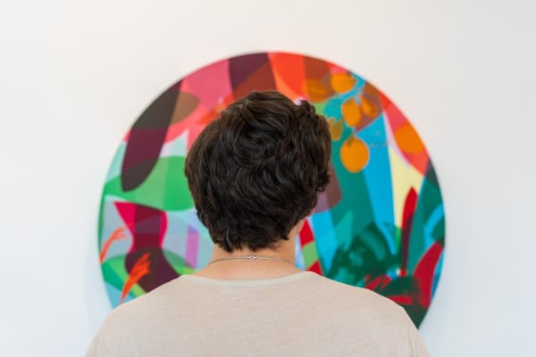 Man staring at painting displayed by Neill Wright inside Carousel Fine Art's Miami gallery space during Neill Wright's exhibition "Where the Light Gets In."