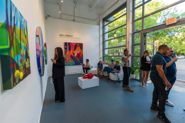 People inside Carousel Fine Art's Miami gallery space during Neill Wright's exhibition "Where the Light Gets In."
