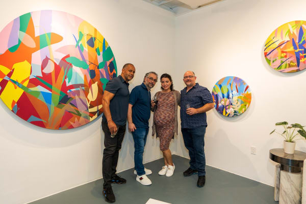 People inside Carousel Fine Art's Miami gallery space during Neill Wright's exhibition "Where the Light Gets In."